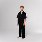 NESHOW black Bambula cotton camp shirt with short sleeves and a relaxed fit, perfect for warm weather.