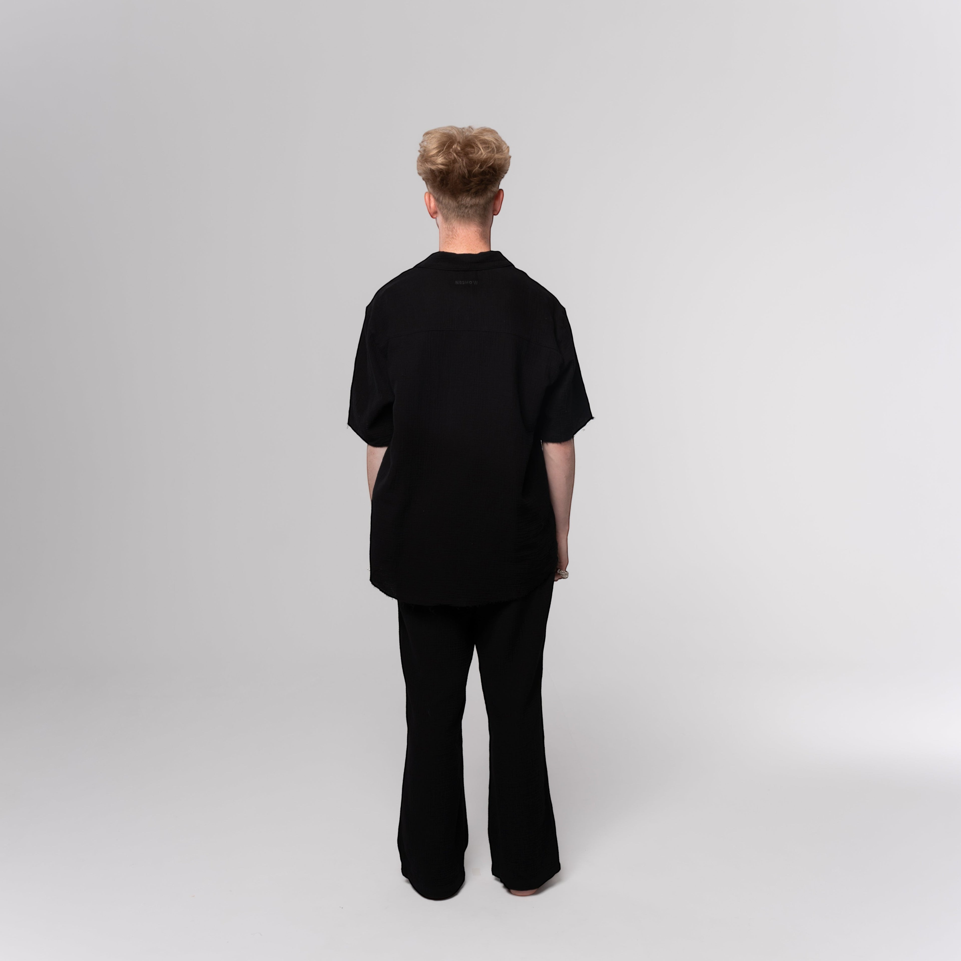 NESHOW black Bambula cotton trousers with a wide-leg fit and breathable, lightweight fabric.