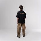 NESHOW black oversized t-shirt made from 320 gsm sustainable cotton with gold logo on back.