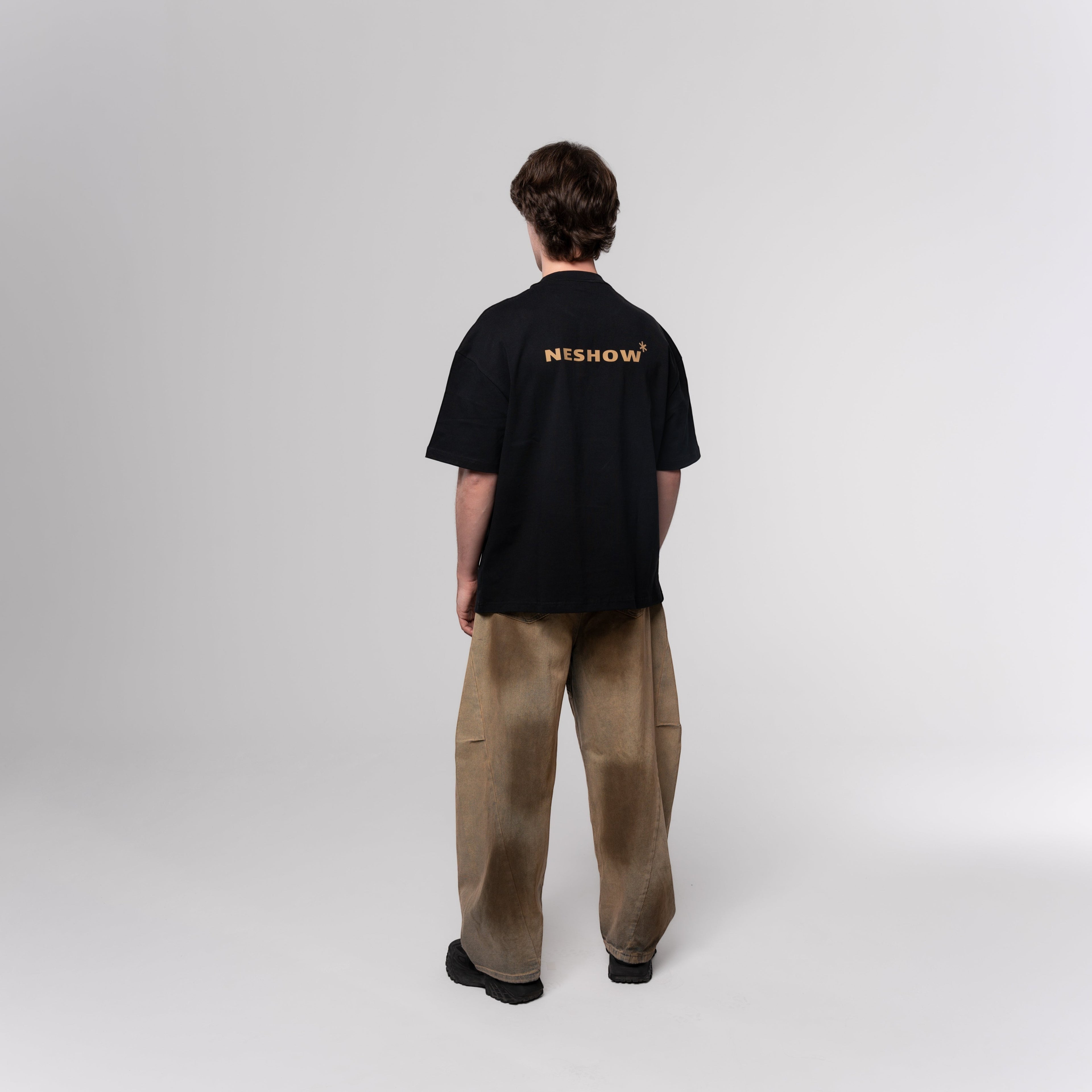 NESHOW black oversized t-shirt made from 320 gsm sustainable cotton with gold logo on back.
