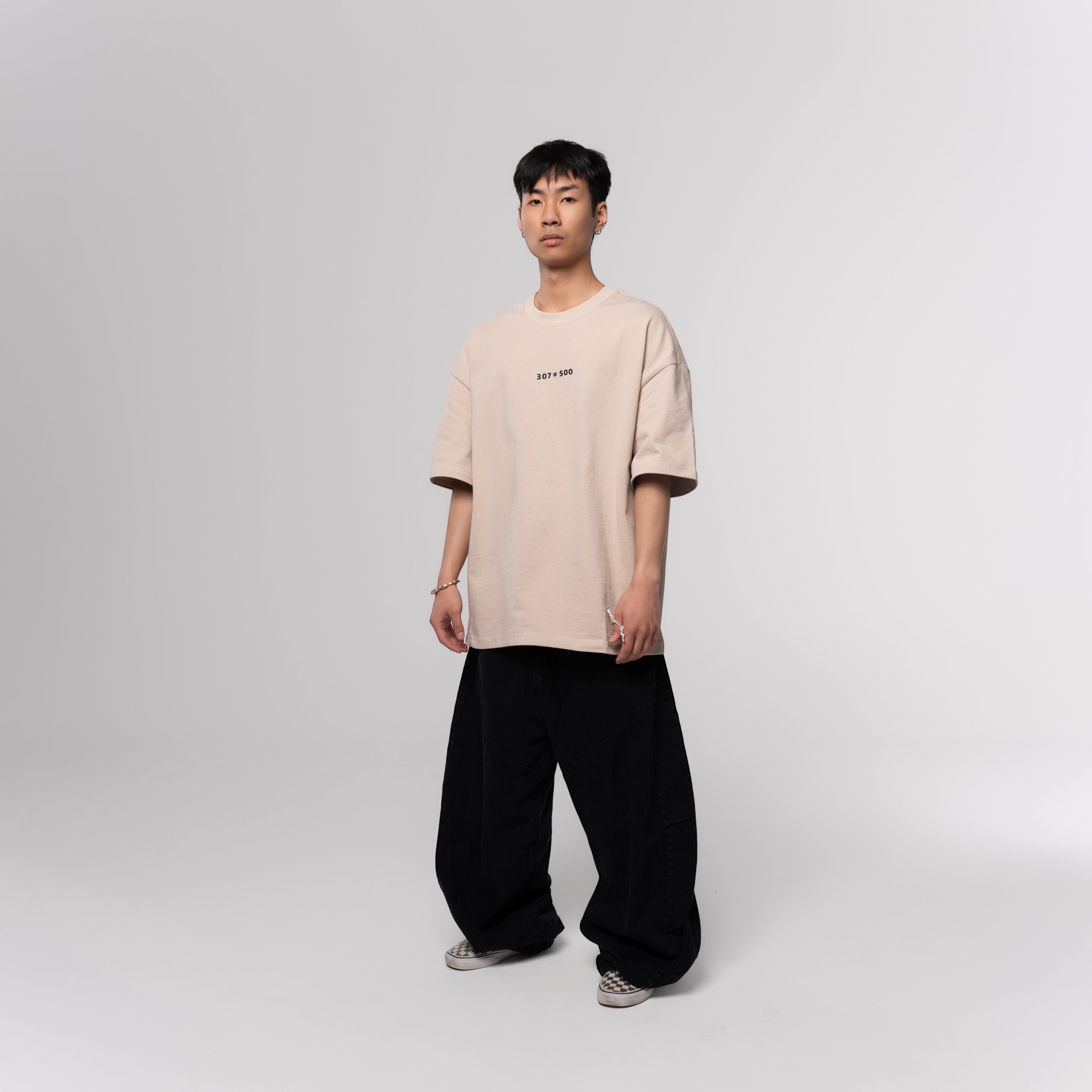 NESHOW oversized beige cotton t-shirt with random number print on front and logo on back. Sustainable 320 gsm cotton.