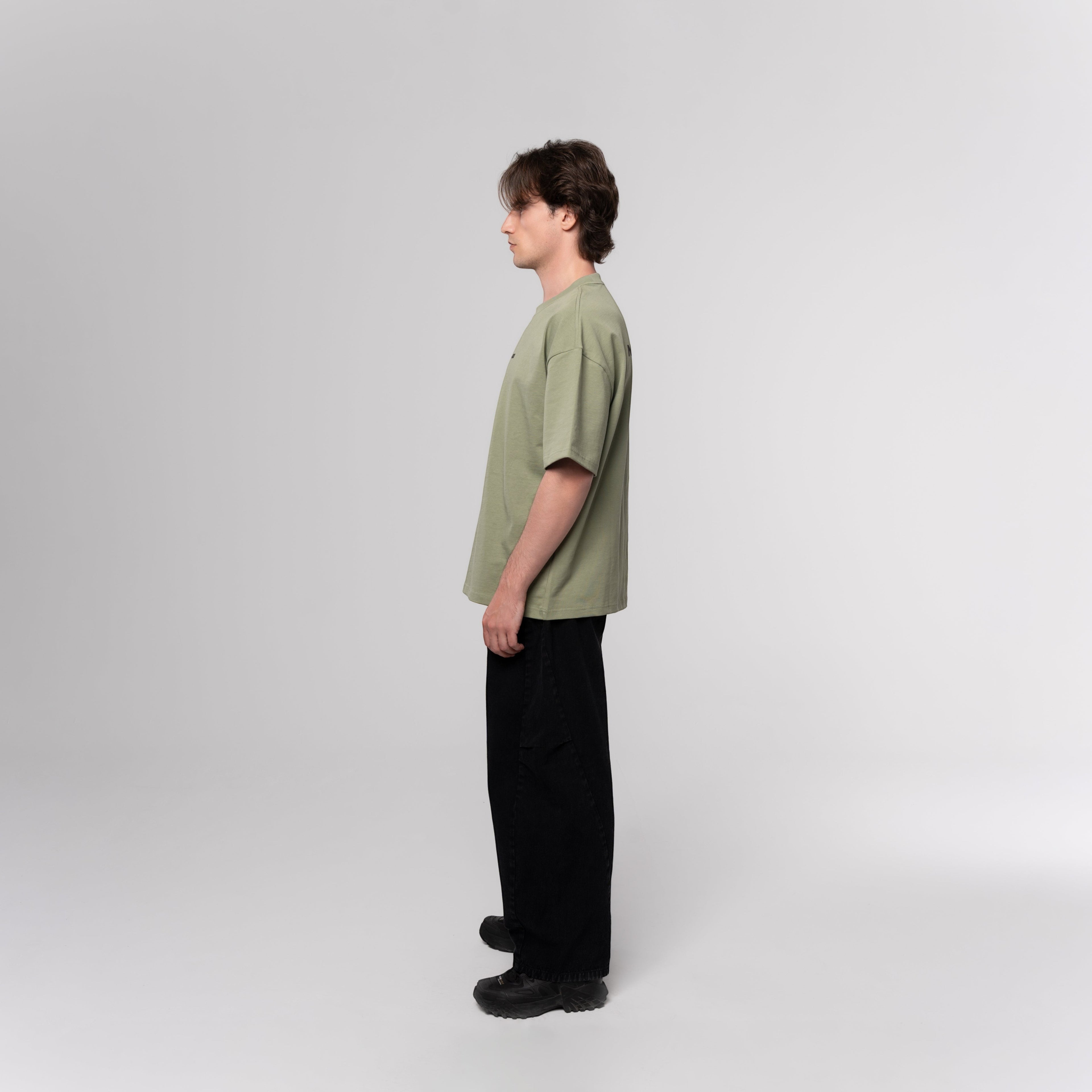 NESHOW oversized sage green 320 gsm sustainable cotton t-shirt with random number print on front and logo on back.