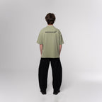 NESHOW oversized light green 320 gsm sustainable cotton t-shirt with black logo on back.