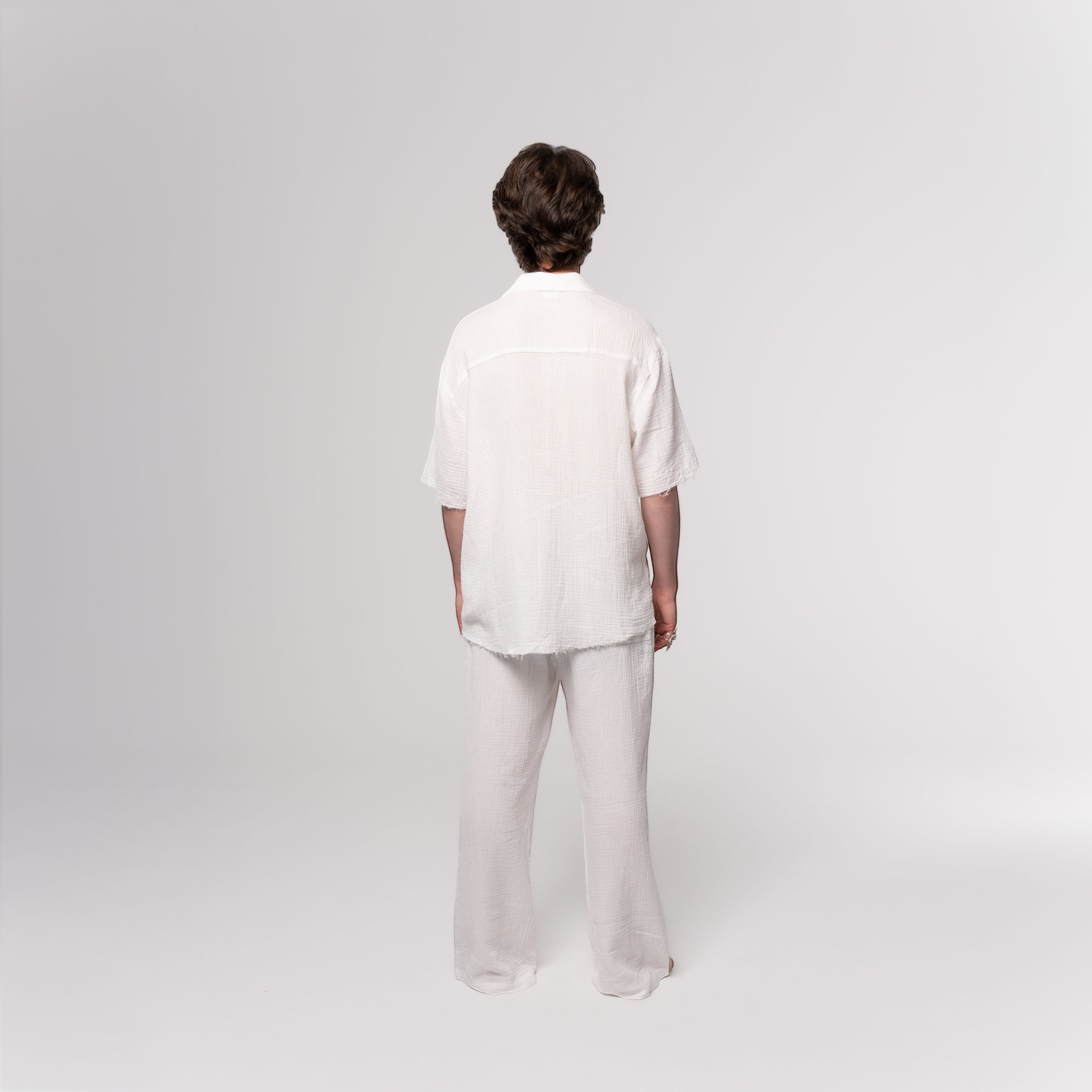 NESHOW white Bambula cotton trousers with a relaxed fit and wide leg, perfect for warm weather.
